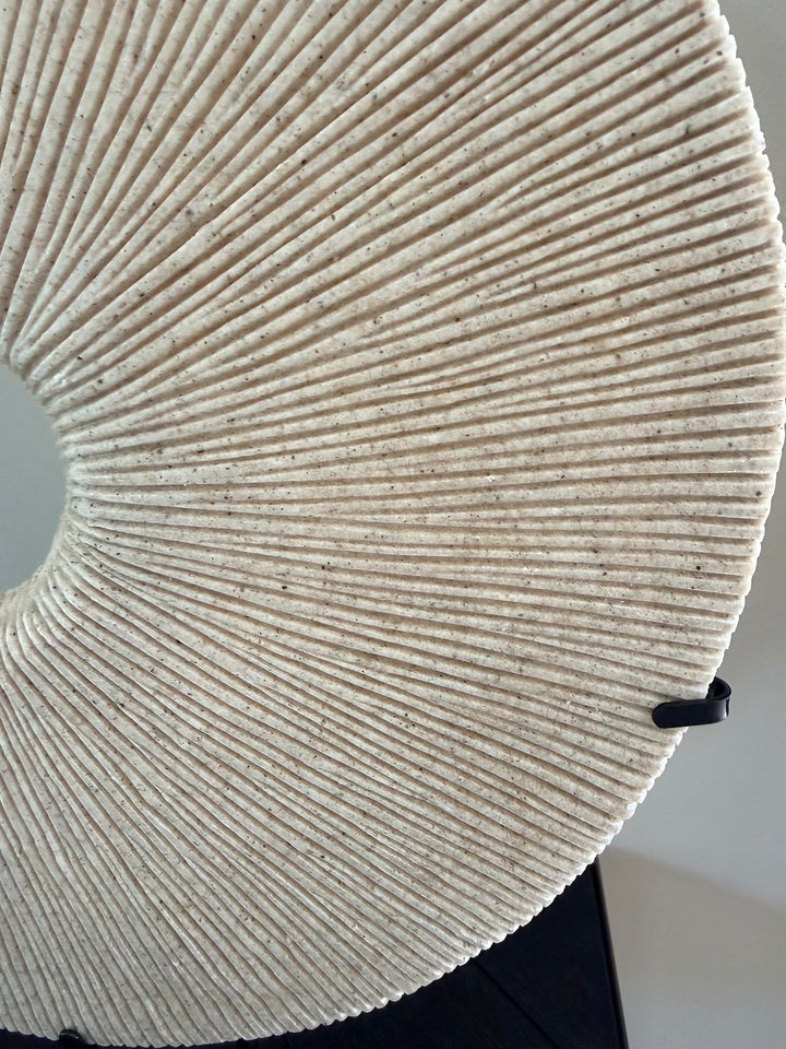 Close-up van de geribbelde structuur van de beige zandstenen decoratie