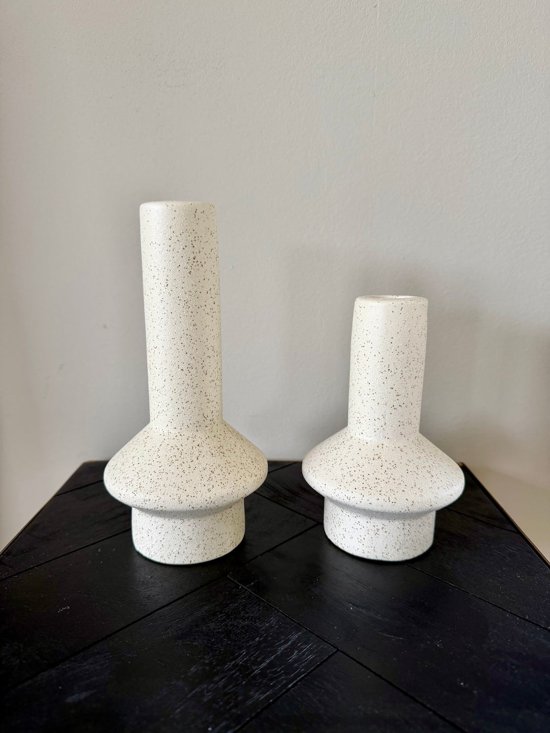 Set keramieken kandelaars in mat crème op donkere houten tafel